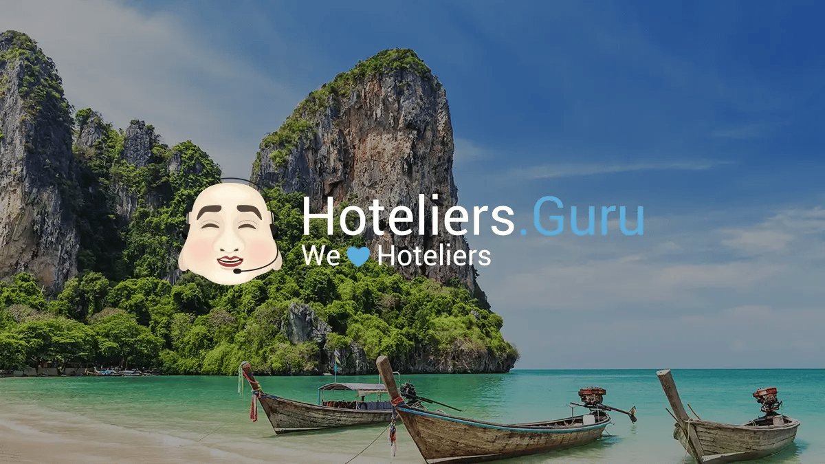 Hoteliers.Guru logo superimposed on of the ocean with three Thai boats.